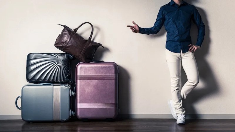Masalah Koper di Jepang: Cara Titip Barang Saat Bepergian 7 A Man in Japan with His Luggage