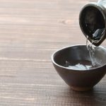 Someone Pours a Cup of Sake in Japan