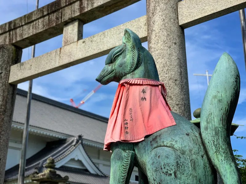 A Fox Statue Torii Gate at Toyokawa Inari